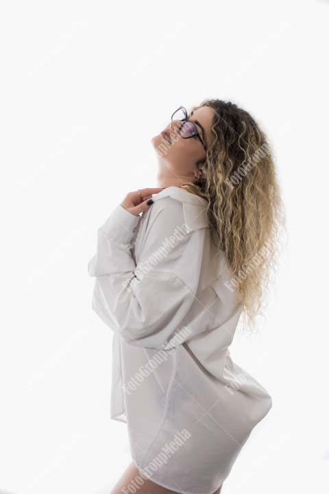 Woman with curly hair and white shirt posing on white background