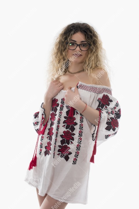 Woman with curly hair and white shirt posing on white background