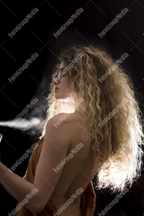 Woman with curly hair wrapped in a scarf posing sexy for camera
