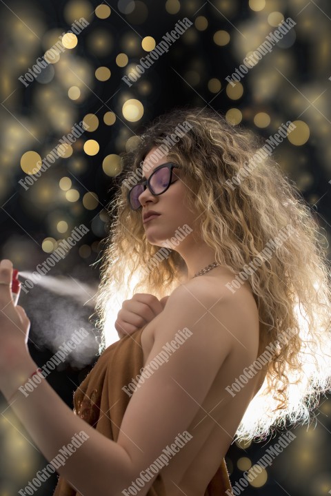 Woman with curly hair wrapped in a scarf posing sexy for camera