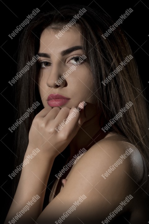 Headshot of beautiful young woman on black background