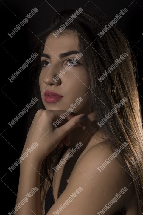 Headshot of beautiful young woman on black background