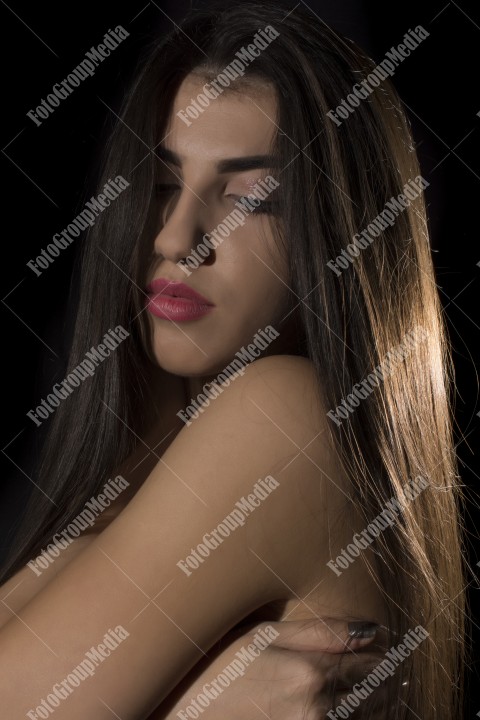 Headshot of beautiful young woman on black background