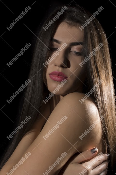 Headshot of beautiful young woman on black background