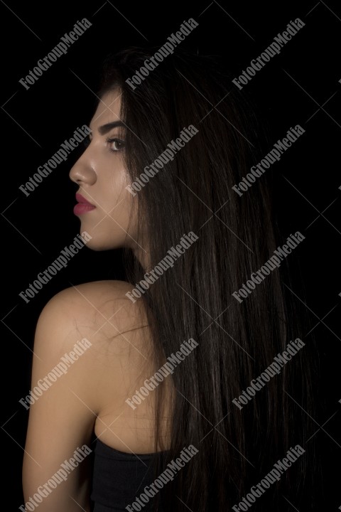 Headshot of beautiful young woman on black background