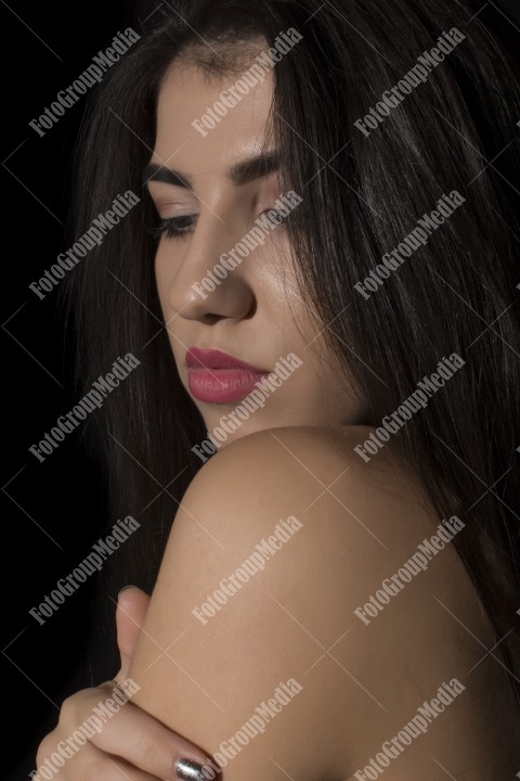 Headshot of beautiful young woman on black background
