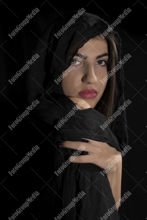 Young woman coverd with headscarf, studio portrait