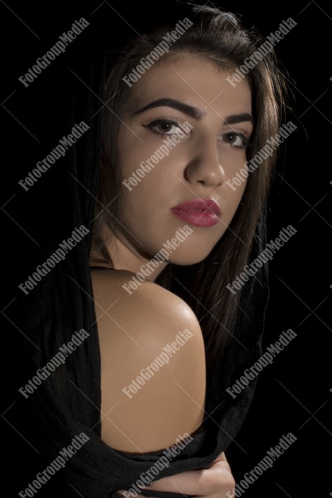 Headshot of beautiful young woman on black background