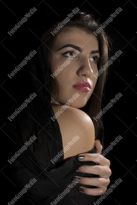 Headshot of beautiful young woman on black background