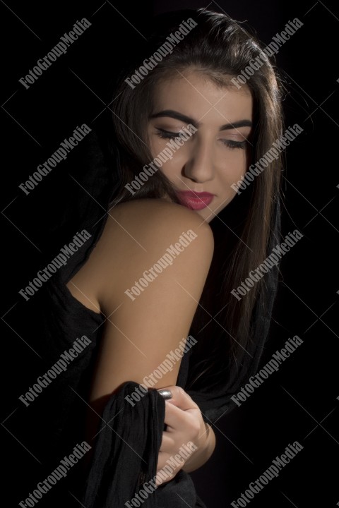 Headshot of beautiful young woman on black background