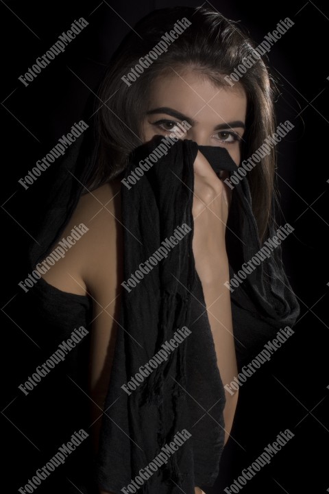 Headshot of beautiful young woman on black background