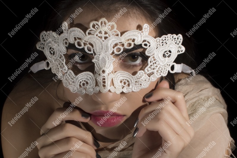 Looking at camera through a lace mask
