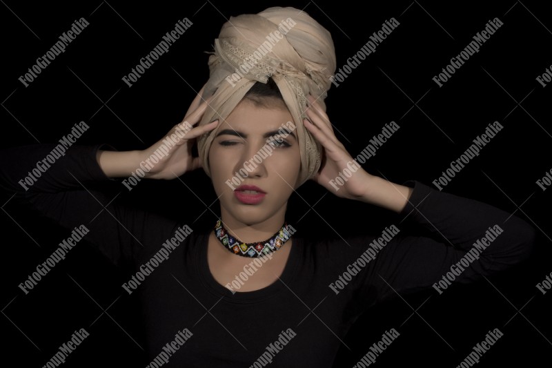 Close up beauty portrait ofyoung woman wearing head dress turban and make up
