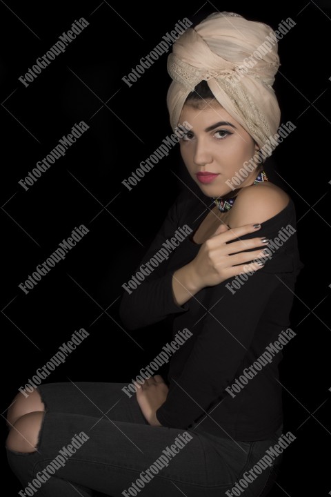 Close up beauty portrait ofyoung woman wearing head dress turban and make up