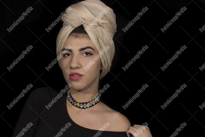 Close up beauty portrait ofyoung woman wearing head dress turban and make up