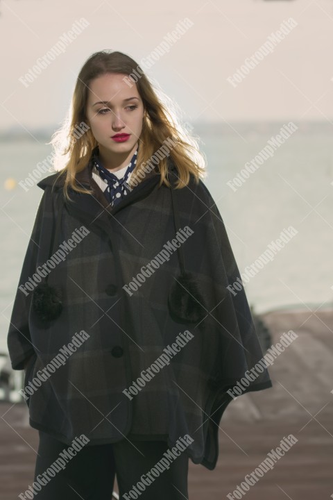 Fashion pose on pier in a cold day