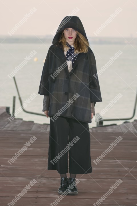 Fashionable young girl posing on pier