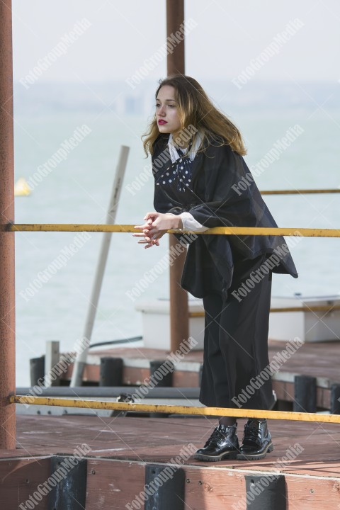 Young girl posing on pier at Lake Siutghiol