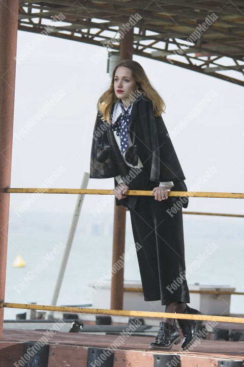 Young girl posing on pier at Lake Siutghiol