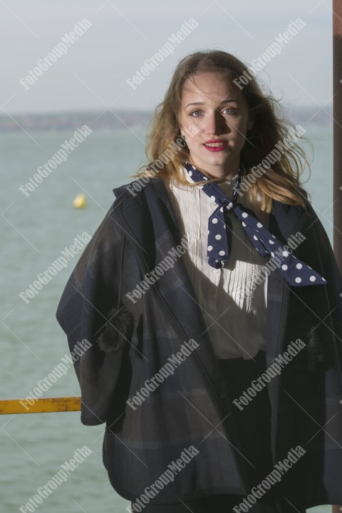 Young girl posing on pier at Lake Siutghiol