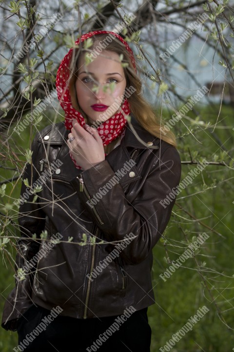 Portrait of a young woman wearing red scarf with white polka dots