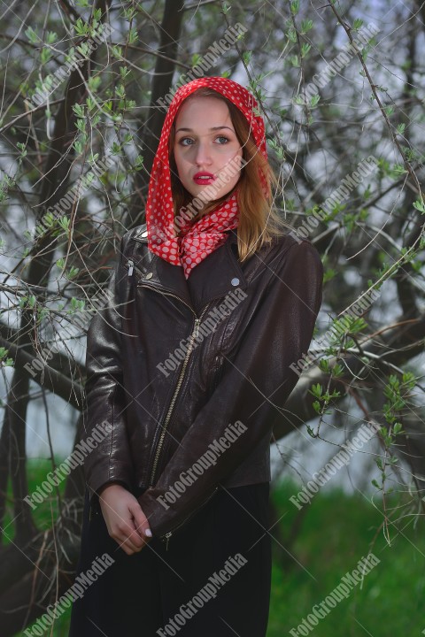 Portrait of a young girl with red scarf with white dots