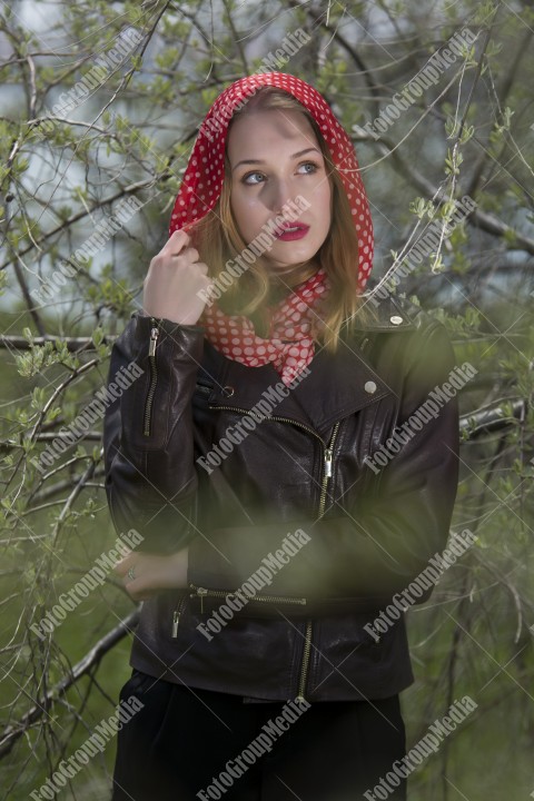 Portrait of a young girl with red scarf with white dots