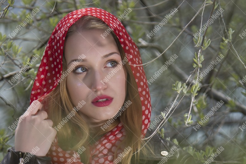 Portrait of a young girl with red scarf with white dots