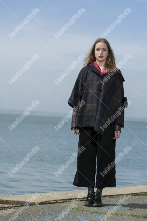 Young girl posing on pier in a cold day