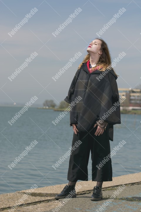 Fashionable young woman walking on pier