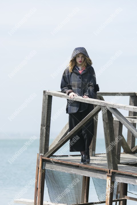 Young girl posing on pier at Lake Siutghiol