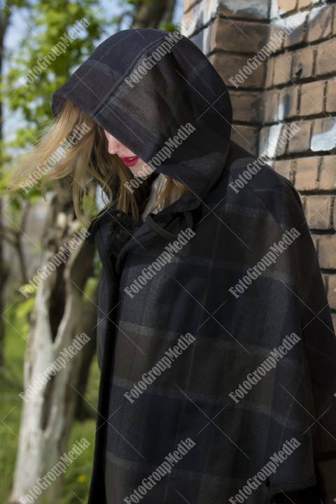 Woman hiding her face under a big hood