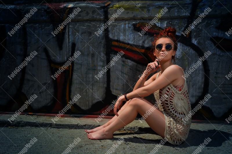 Beautiful redhead young woman in a stylish summer knit clothes posing outdoor