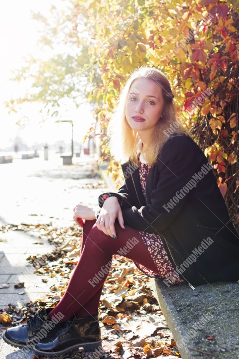 Outdoor portrait of a young lady with red dress