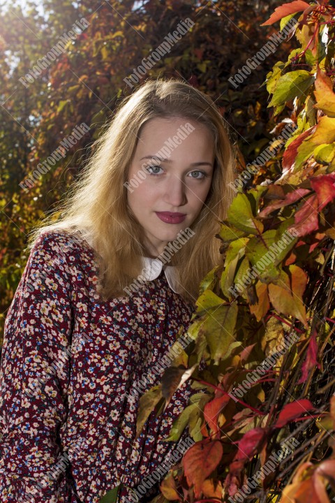 Outdoor portrait using colorful leafs as background