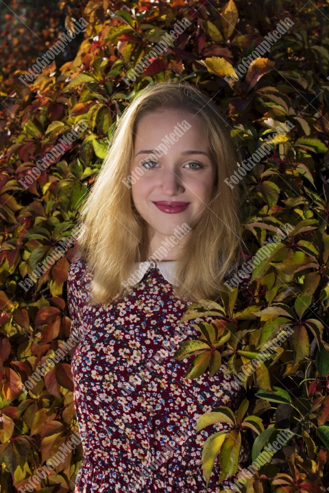 Outdoor portrait using colorful leafs as background