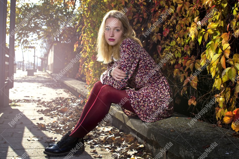 Outdoor portrait of a young lady with red dress