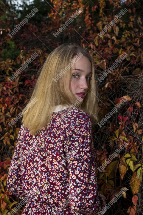 Outdoor portrait using colorful leafs as background