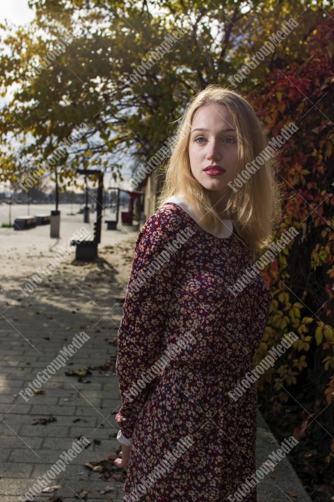 Girl with red dress and posing on street