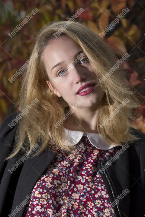 Outdoor portrait using colorful leafs as background