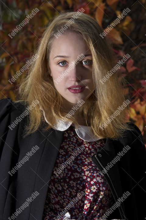 Outdoor portrait using colorful leafs as background