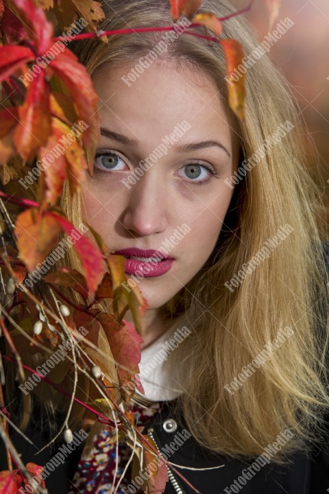 Art portrait of a young blonde woman in autumn background