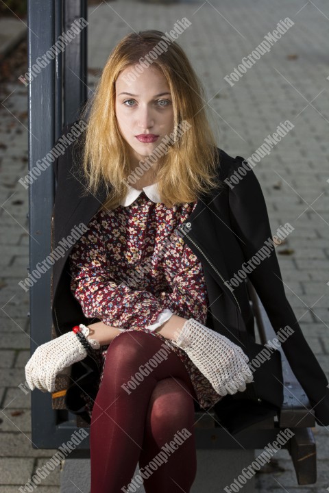 Girl with red dress and white gloves on street