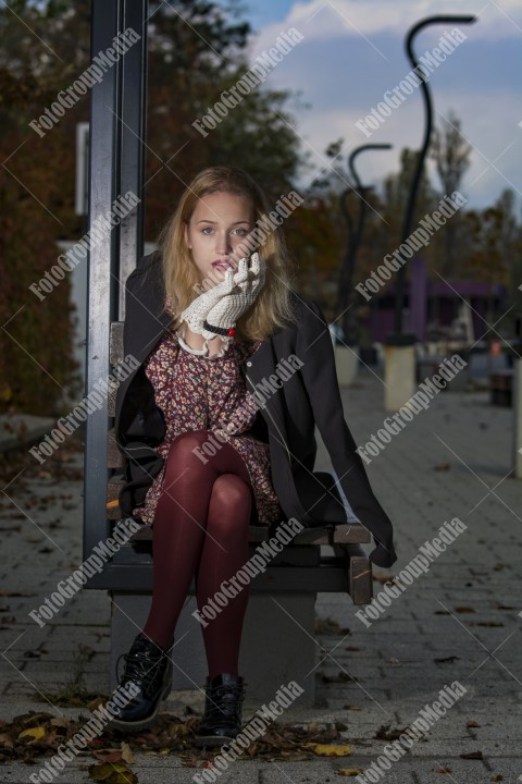 Girl with red dress and white gloves on street