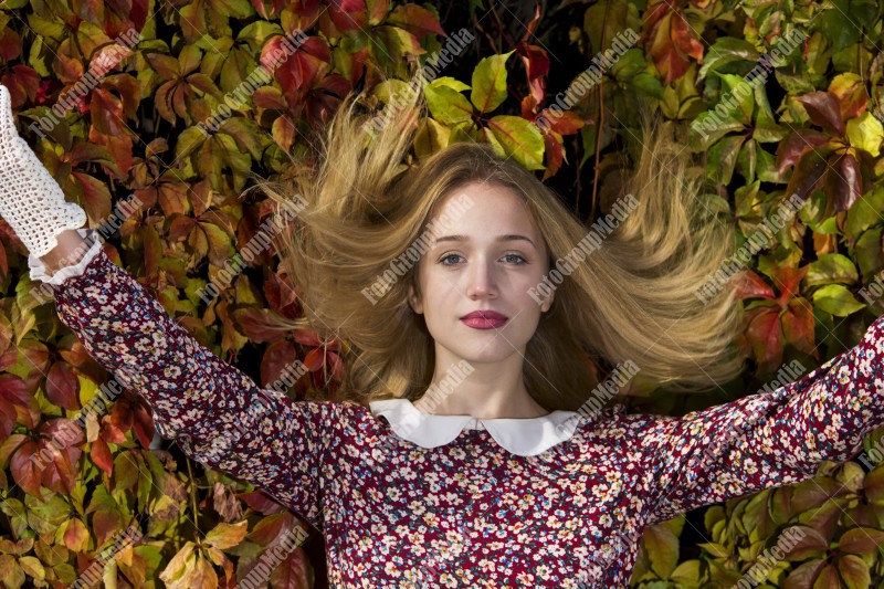 Outdoor portrait using colorful leafs as background