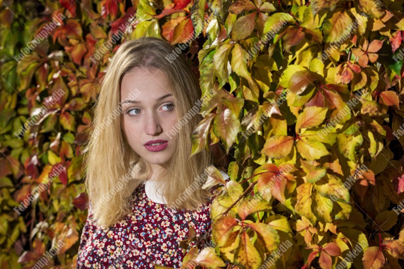 Outdoor portrait using colorful leafs as background