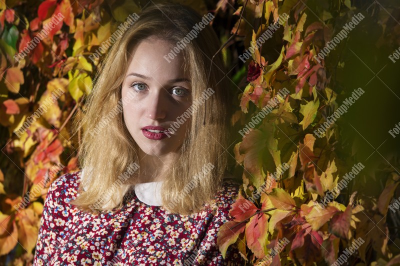 Outdoor portrait using colorful leafs as background