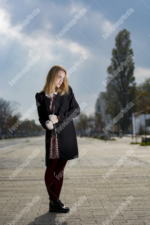 Girl with red dress and leather jacket on street