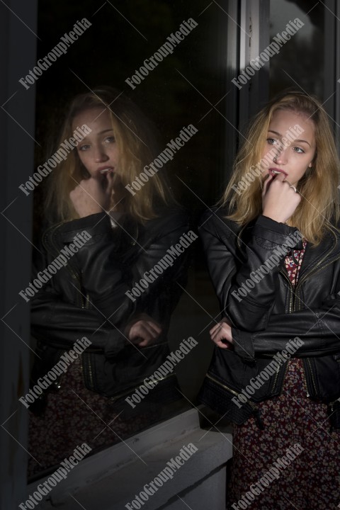 Young woman, window reflection