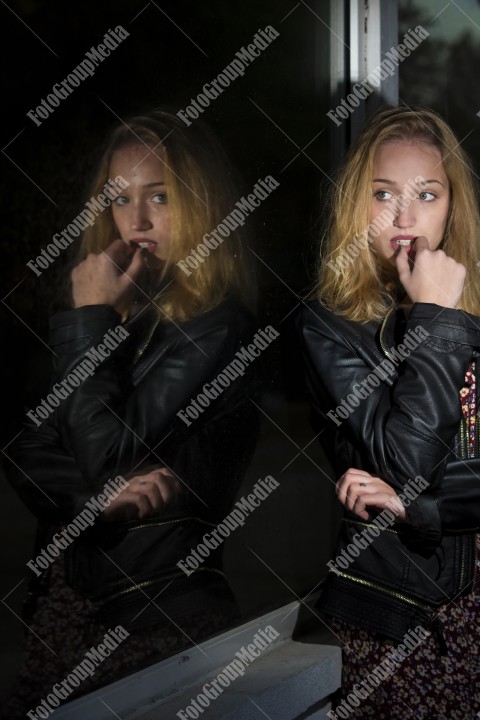 Young woman, window reflection